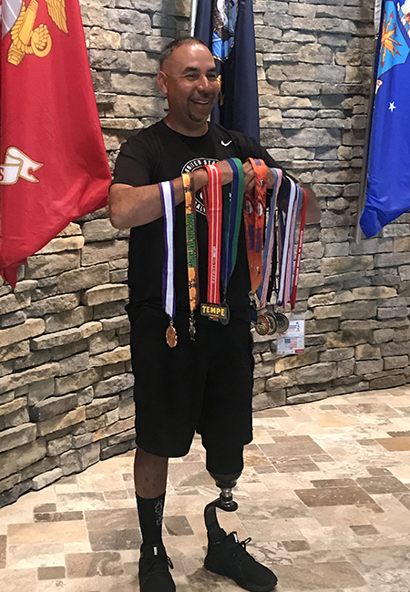 Richard Alcaraz holding medals
