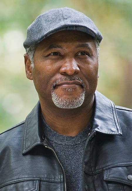 man wearing hat walking outside