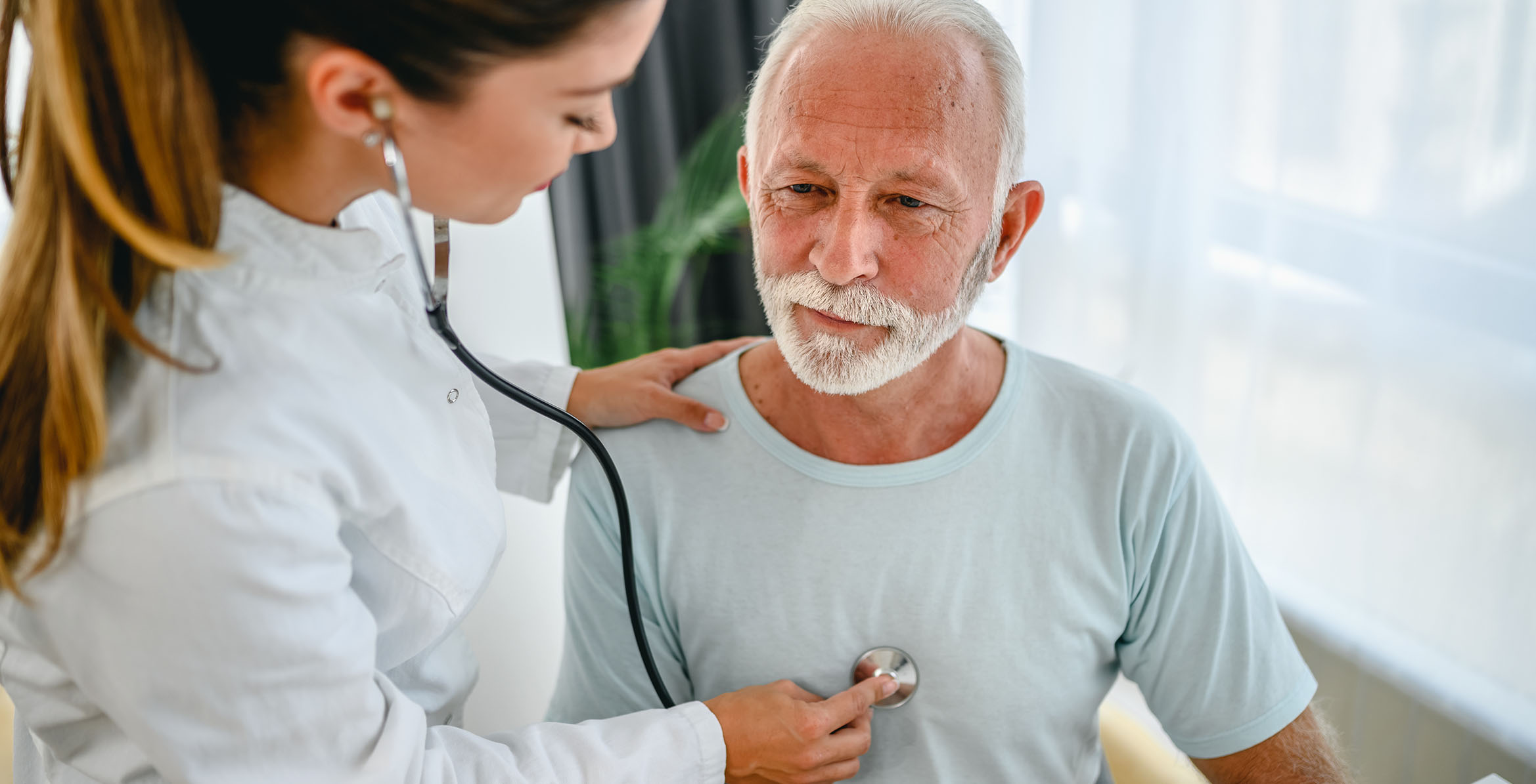 Doctor listening to patients heart