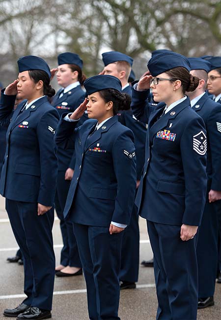 Group of female service members saluting