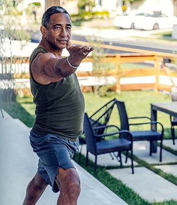 Man doing yoga on front porch