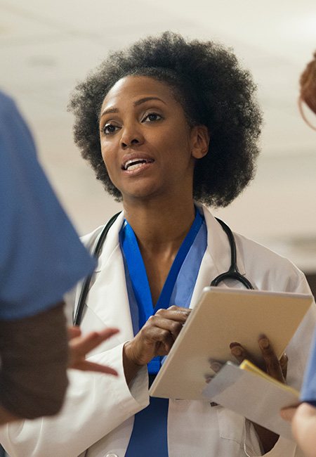 doctor speaking with staff