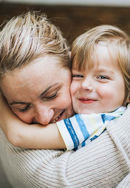 Mother and son embracing