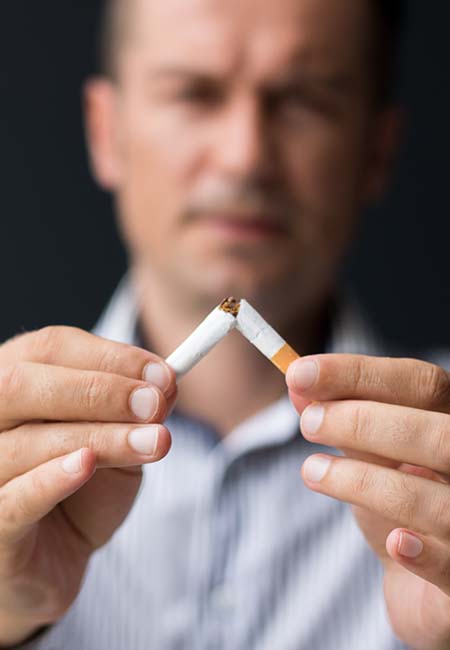 man breaking cigarette