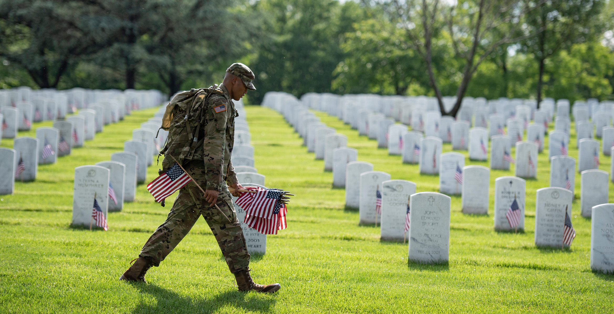 Service member placing flags on Memorial Day