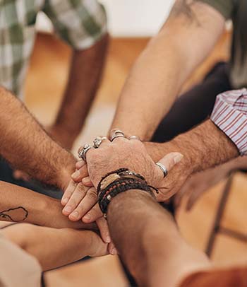 people holding hands in support group