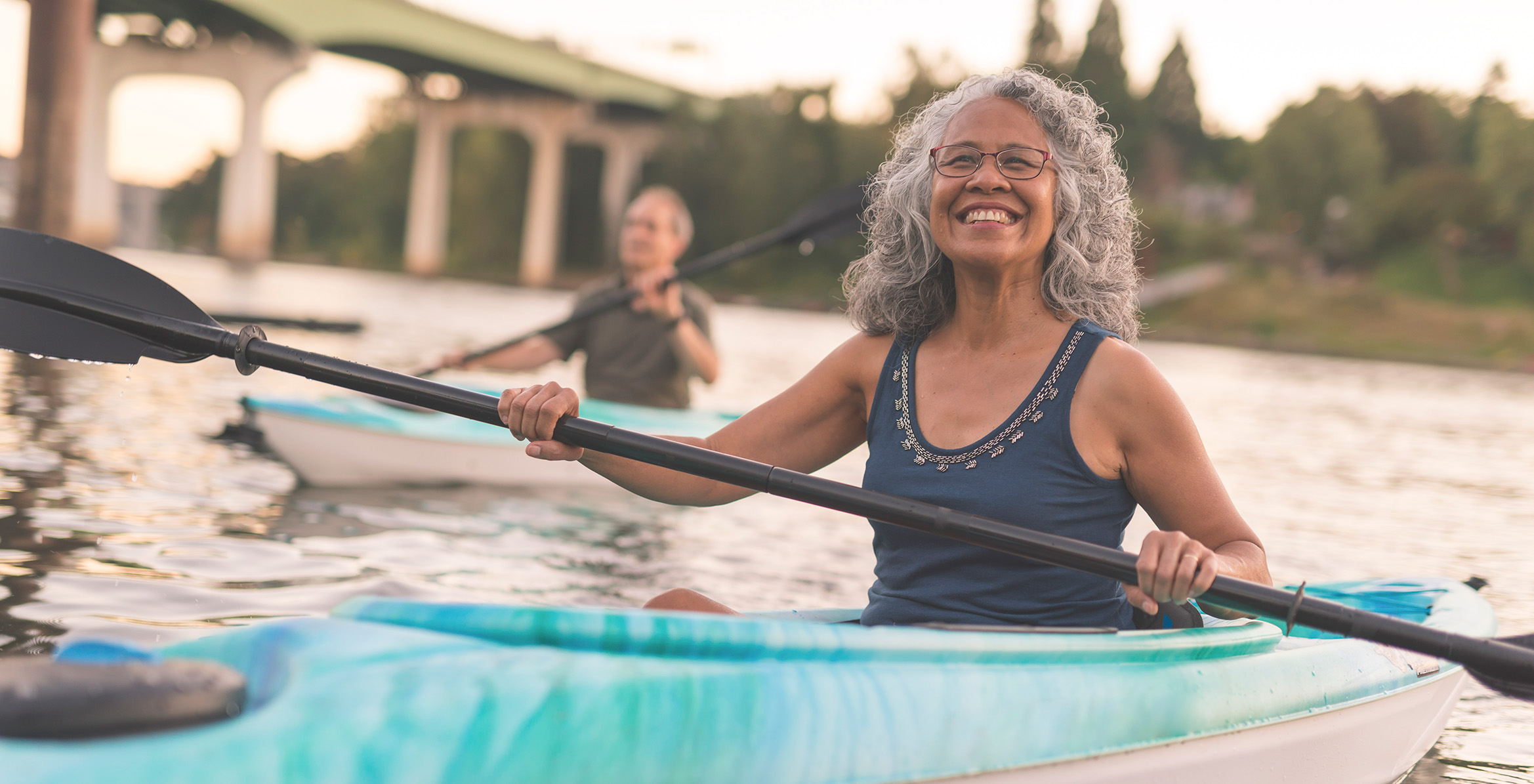 Senior woman smiles while kayaking