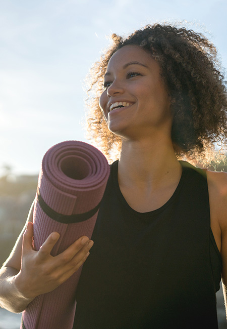 Woman holding a yoga mat
