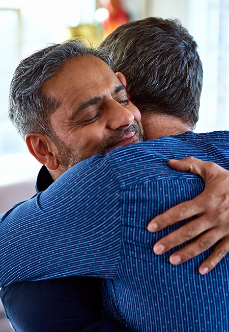 Male friends hugging