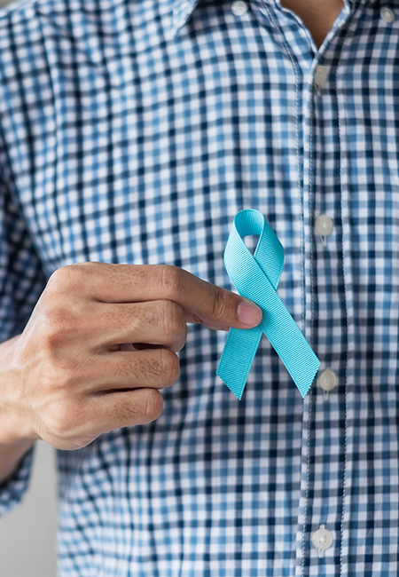 Man holding blue ribbon