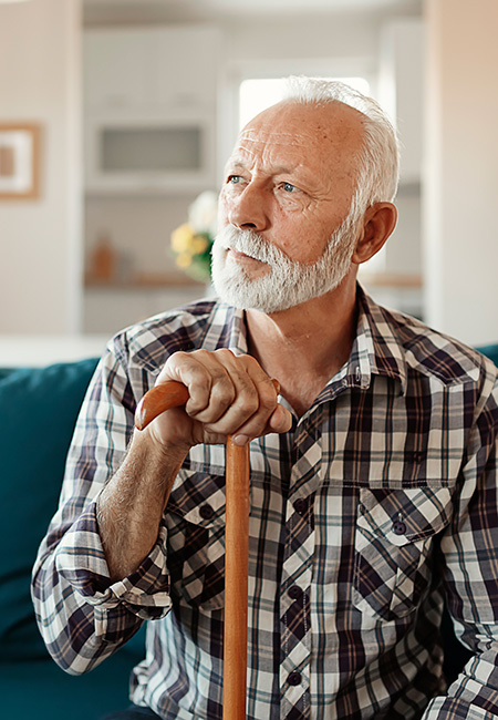 Senior man with cane at home