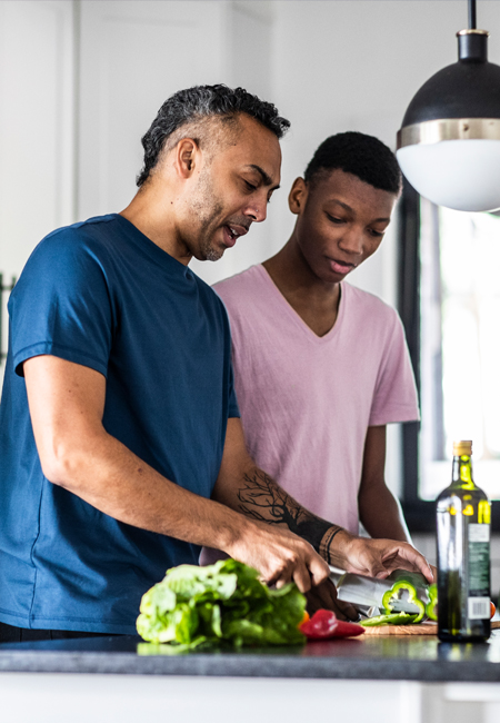 Father and son chopping vegetables