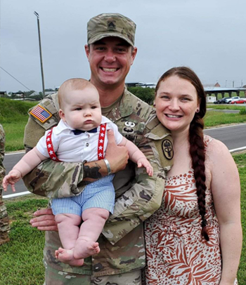 Happy military couple with baby