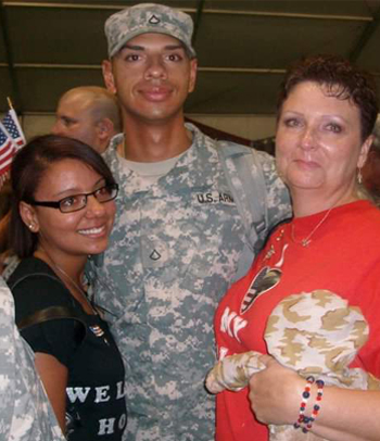 Mother and daughter with military son smiling