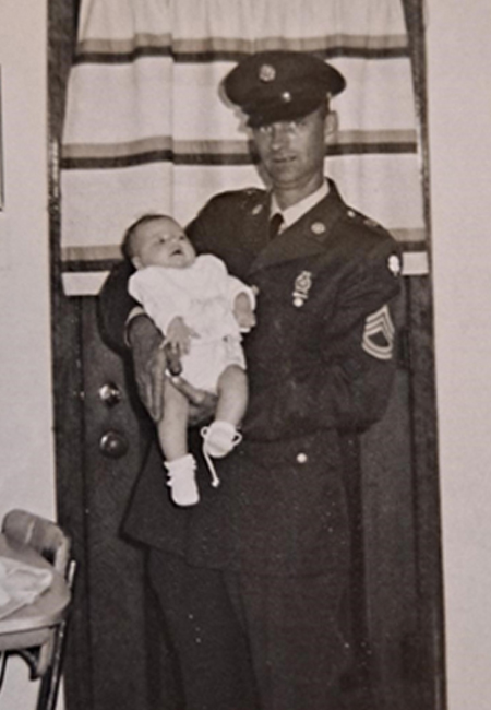 Vintage photo of father holding infant daughter