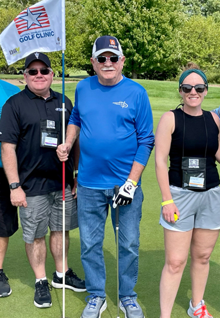 Smiling group of veterans at the National Disabled Veterans Golf Clinic event