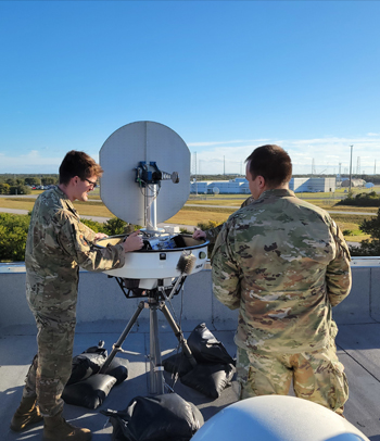 Space Force members working with weather equipment 