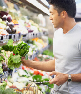 Hispanic man shopping for vegetables