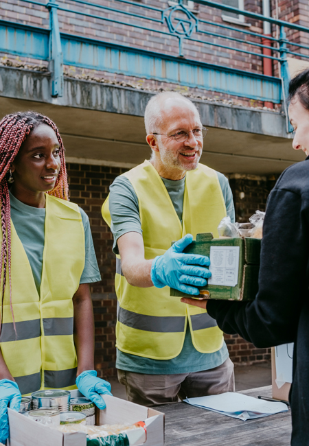man and woman volunteering at food drive