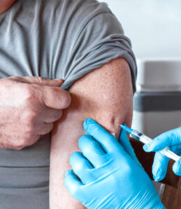Man receiving vaccination from doctor