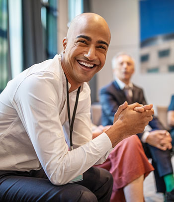 corporate professional smiling during a seminar in convention center