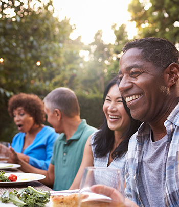 Friends having fun at an outdoors picnic.