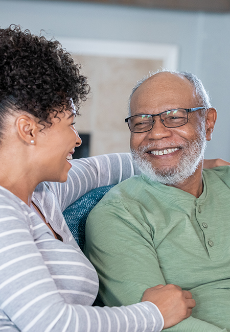 Adult daughter laughing with senior father.