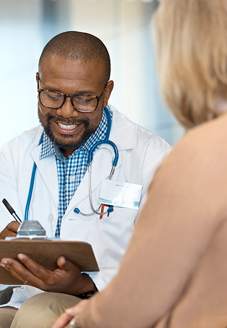 Doctor discussing with patient in hospital.