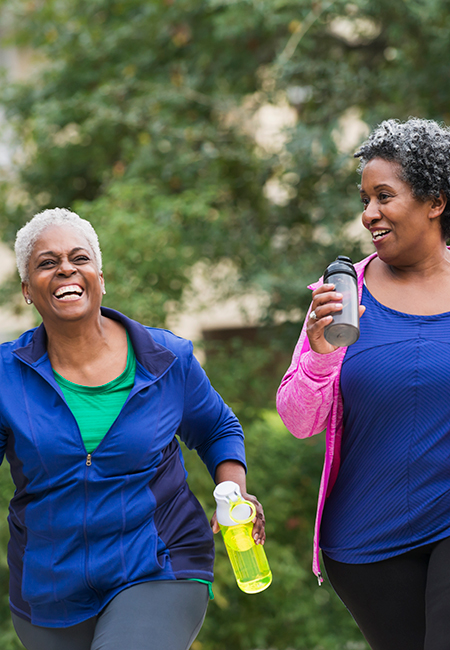 Two senior women exercising together.
