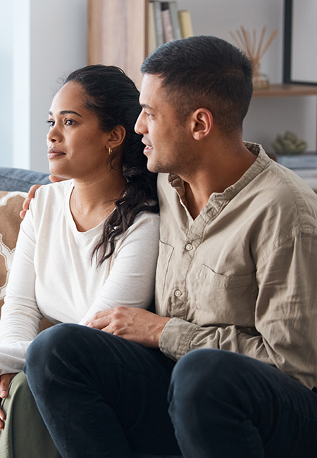 A happy young couple sitting together during a therapy session.