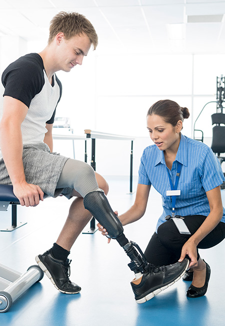 Young man with limb loss having physical therapy.