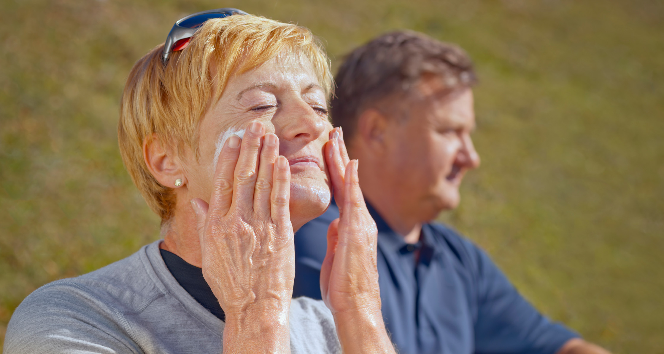 Woman applying sunscreen.