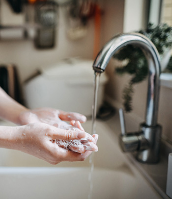 Woman washing hands.