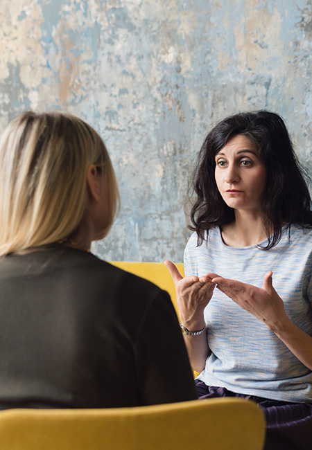 Woman psychologist talking to patient.