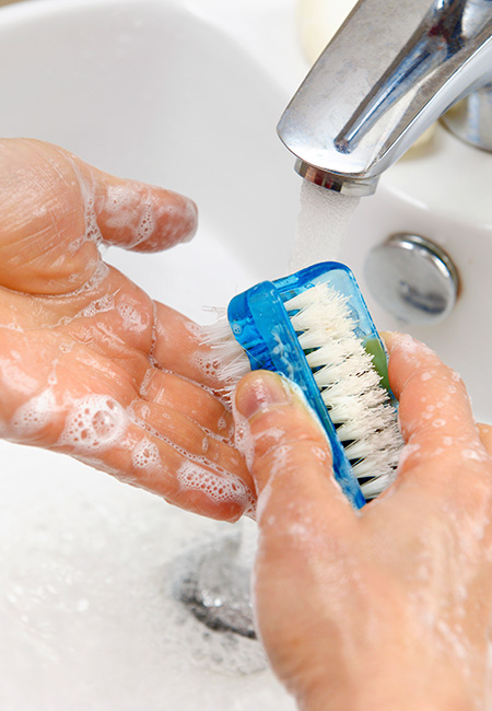 Woman with OCD washing hands.