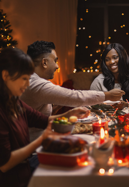 Friends having Christmas dinner at home.