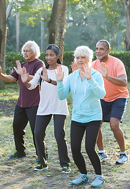 Group of Seniors taking a tai chi class in the park.