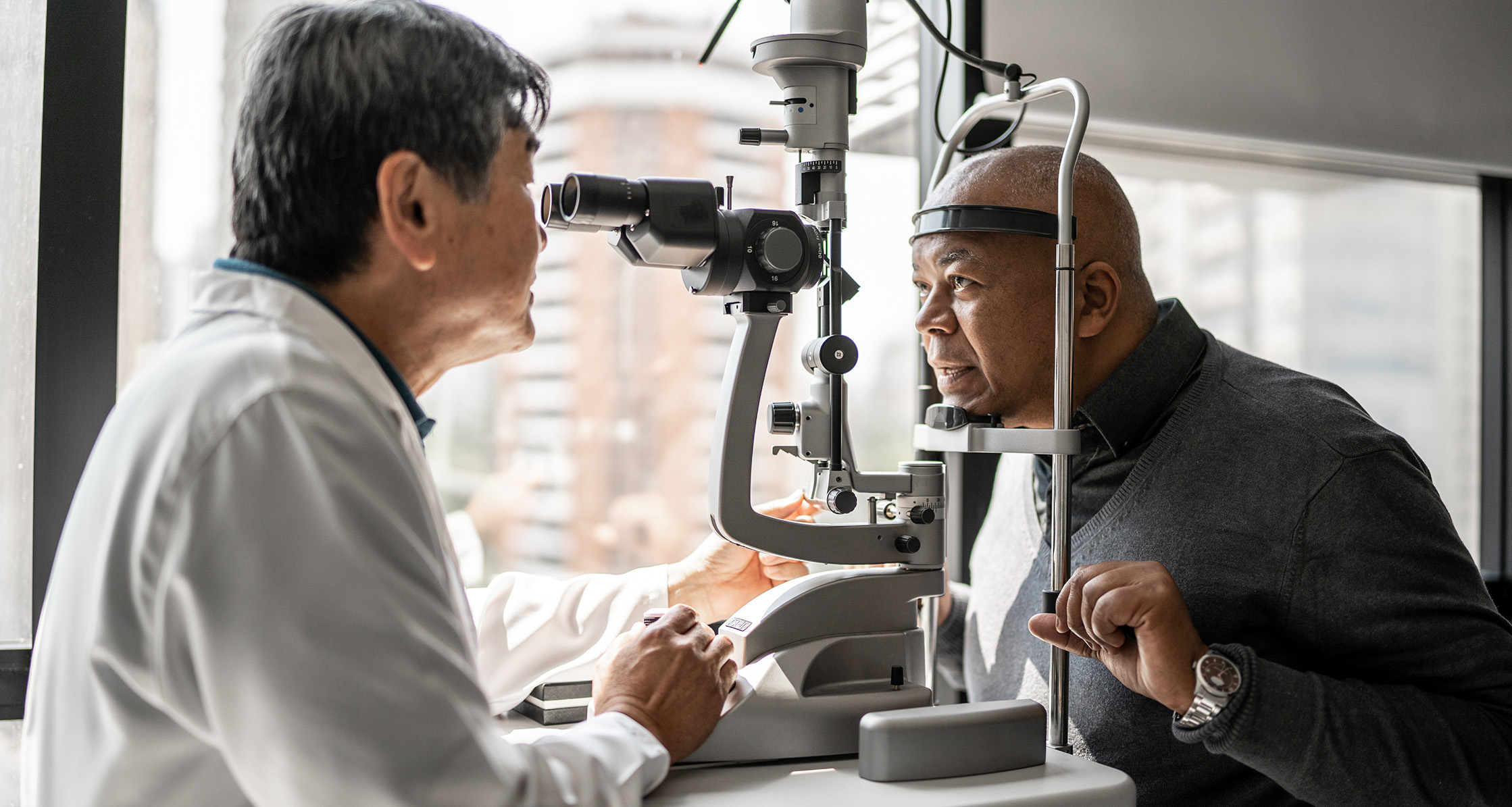Ophthalmologist examining patient’s eyes.