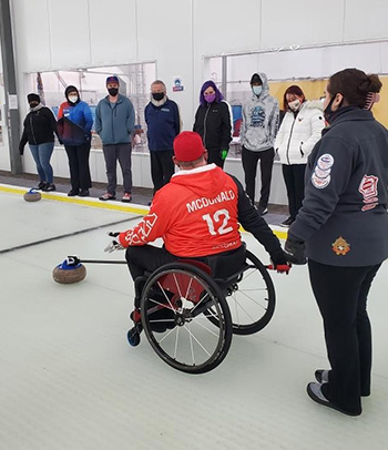 Patrick McDonald coaches his daughter’s curling team.