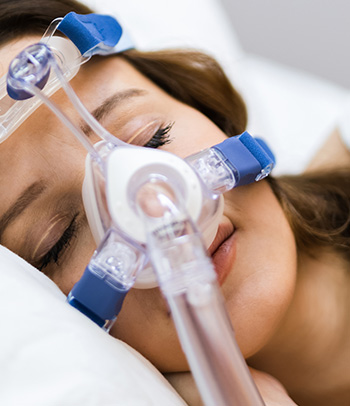 Woman using sleep apnea equipment.
