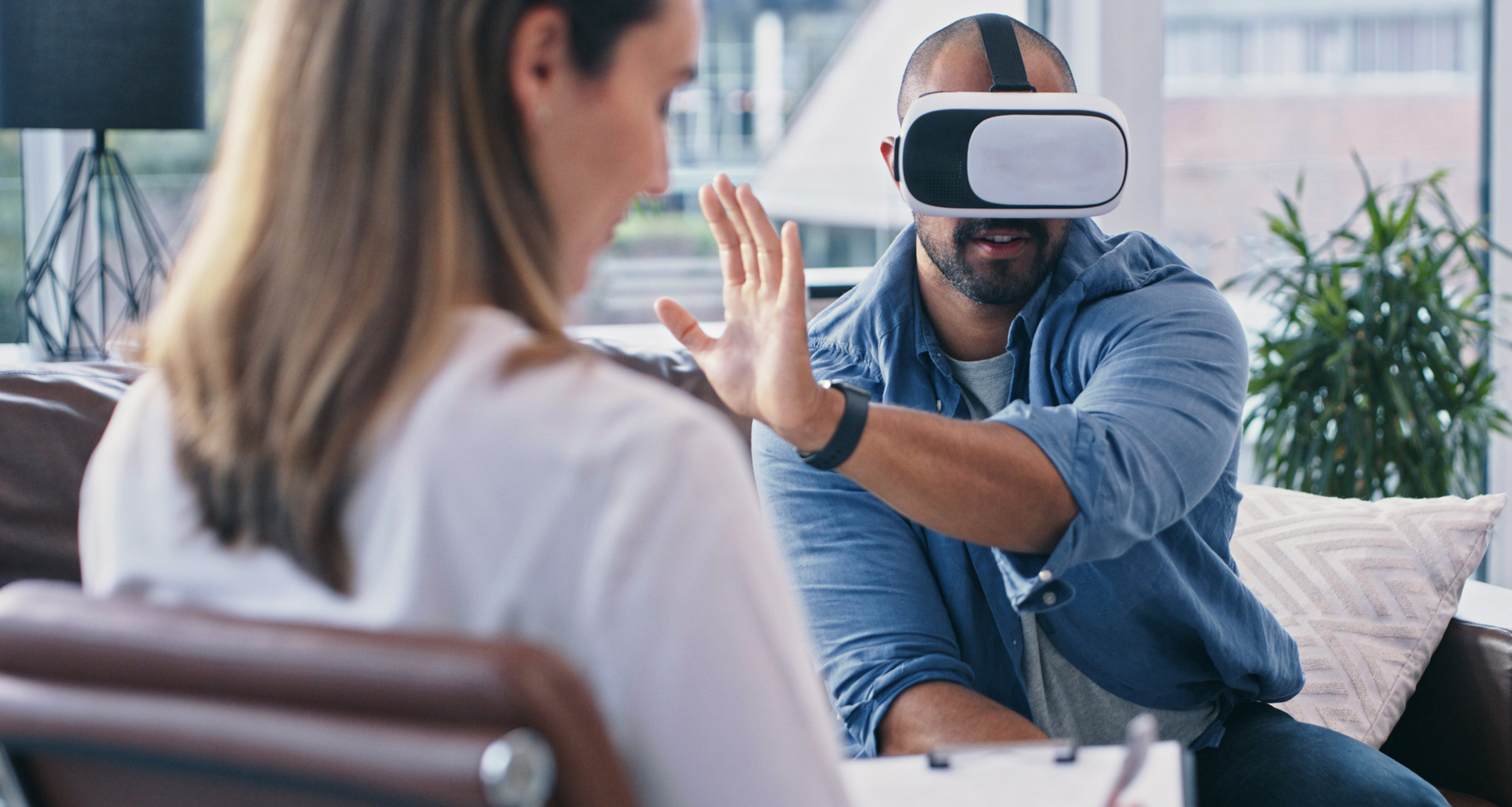 Man wearing a VR headset while sitting in a session.