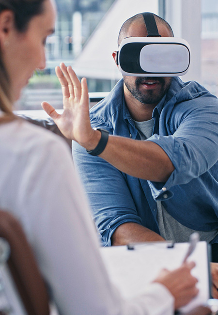 Man wearing a VR headset while sitting in a session.