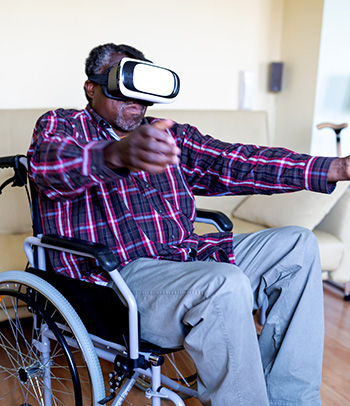 Senior disabled Veteran wearing VR headset at home.