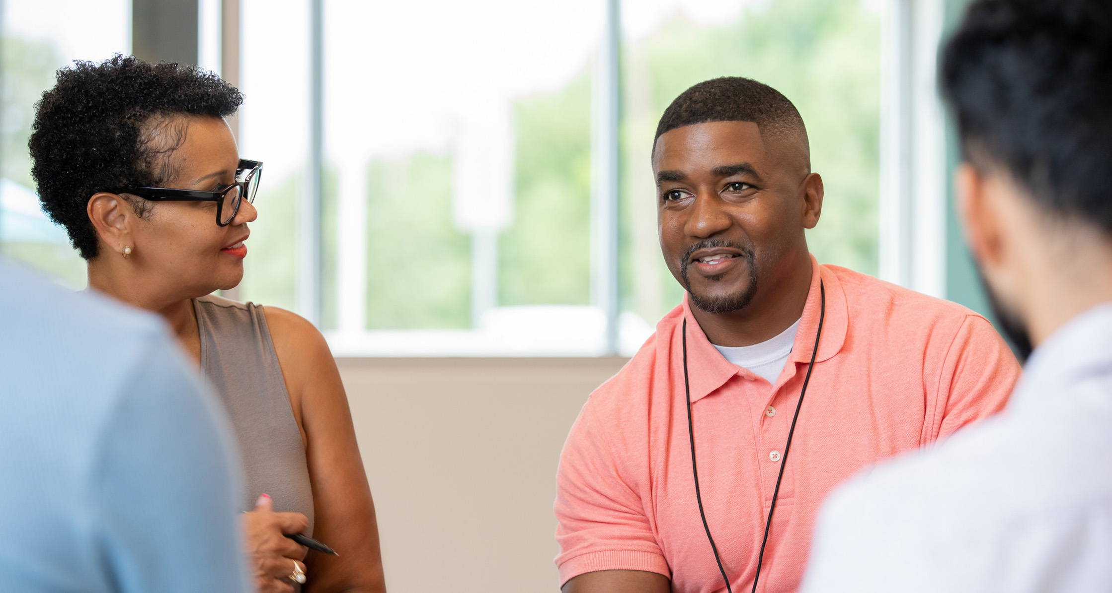 A therapist leads a group of Veterans to discuss coping skills.