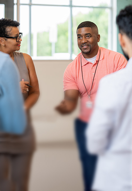 A therapist leads a group of Veterans to discuss coping skills.