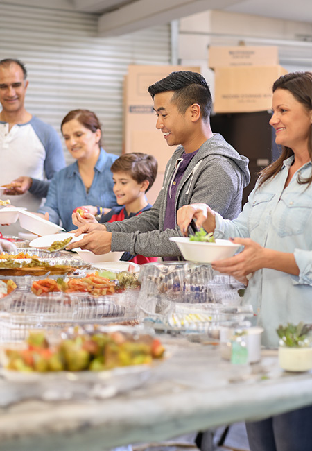 A young couple enjoys a hot meal together at a soup kitchen.
