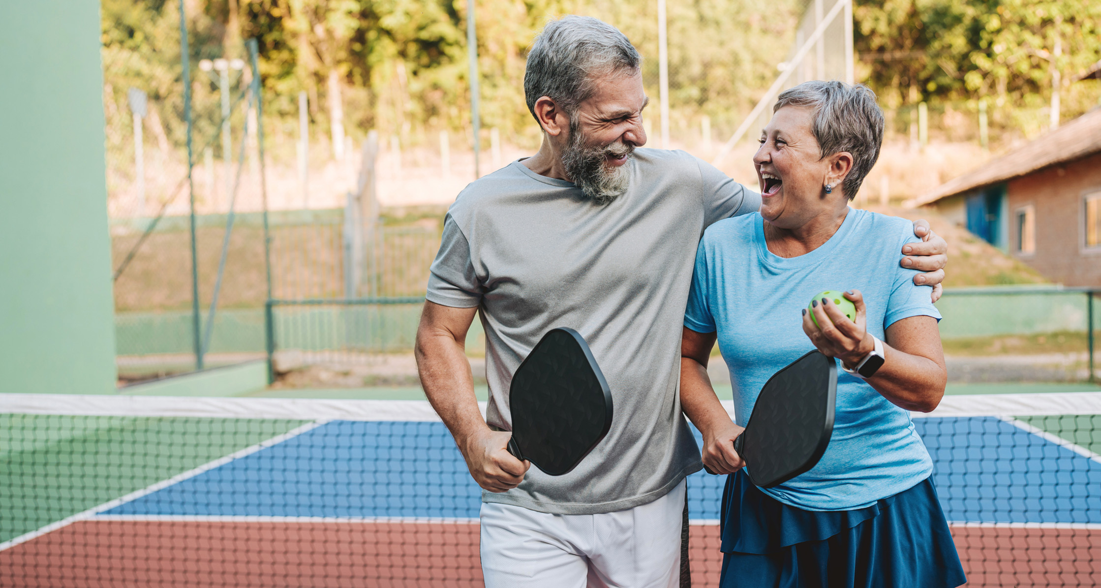 Playing pickleball together, this retired couple enjoys an active and fun moment.