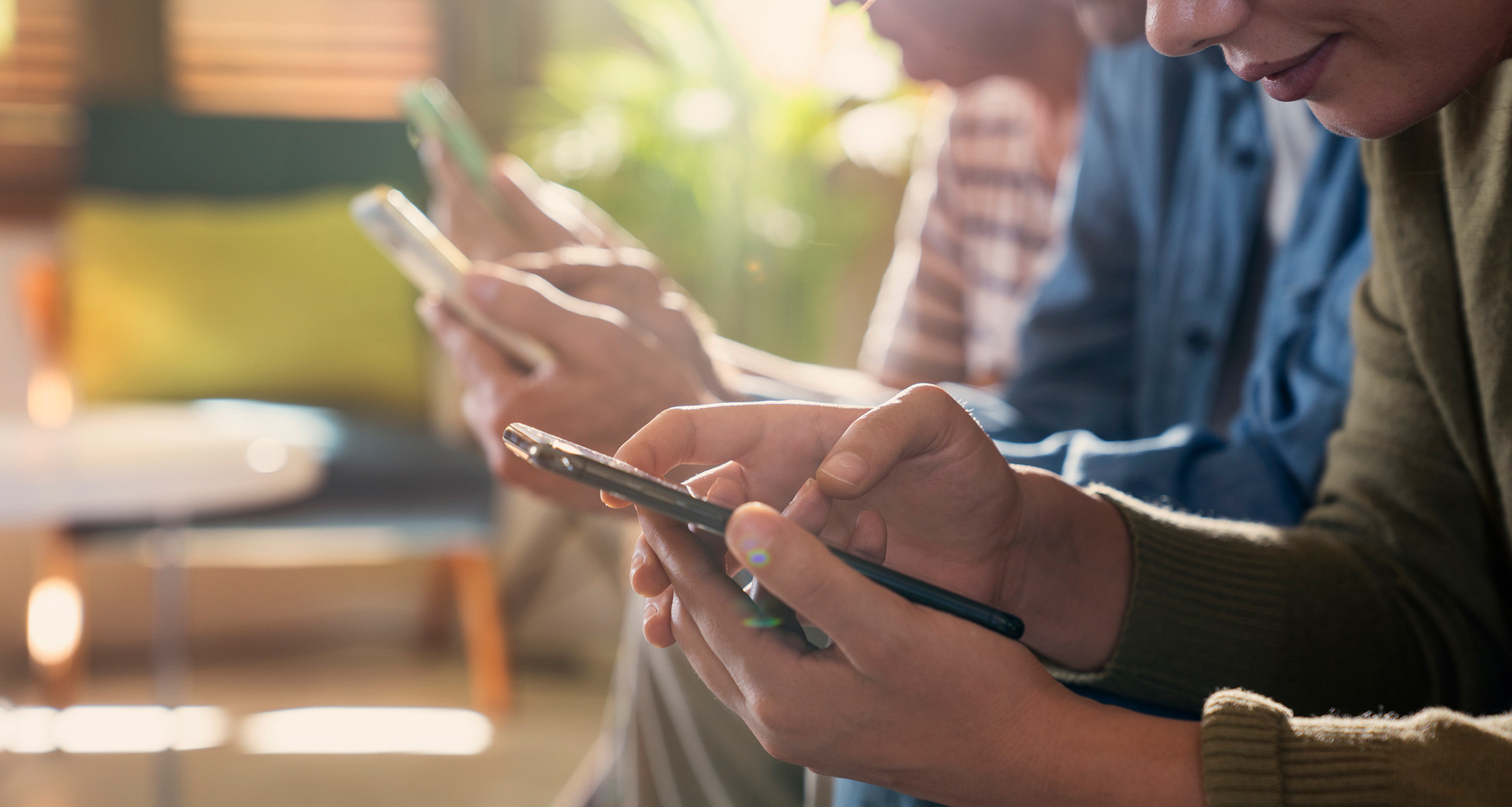 A close-up of hands using smartphones while actively engaging with online content.