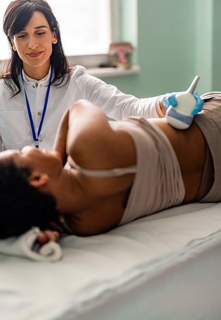 A woman is undergoing an ultrasound examination of her liver by her doctor.