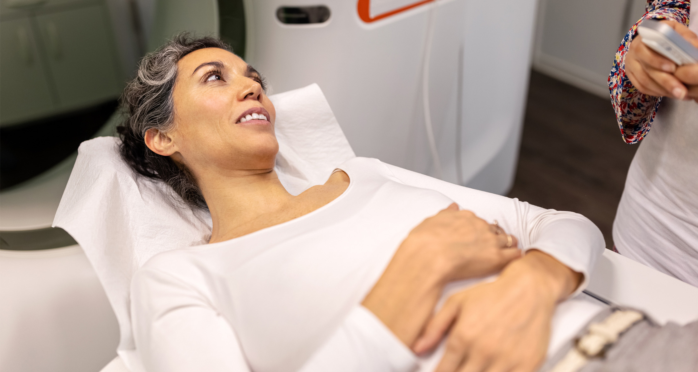 A female patient is undergoing a CT scan at the hospital for symptoms of uterine cancer.